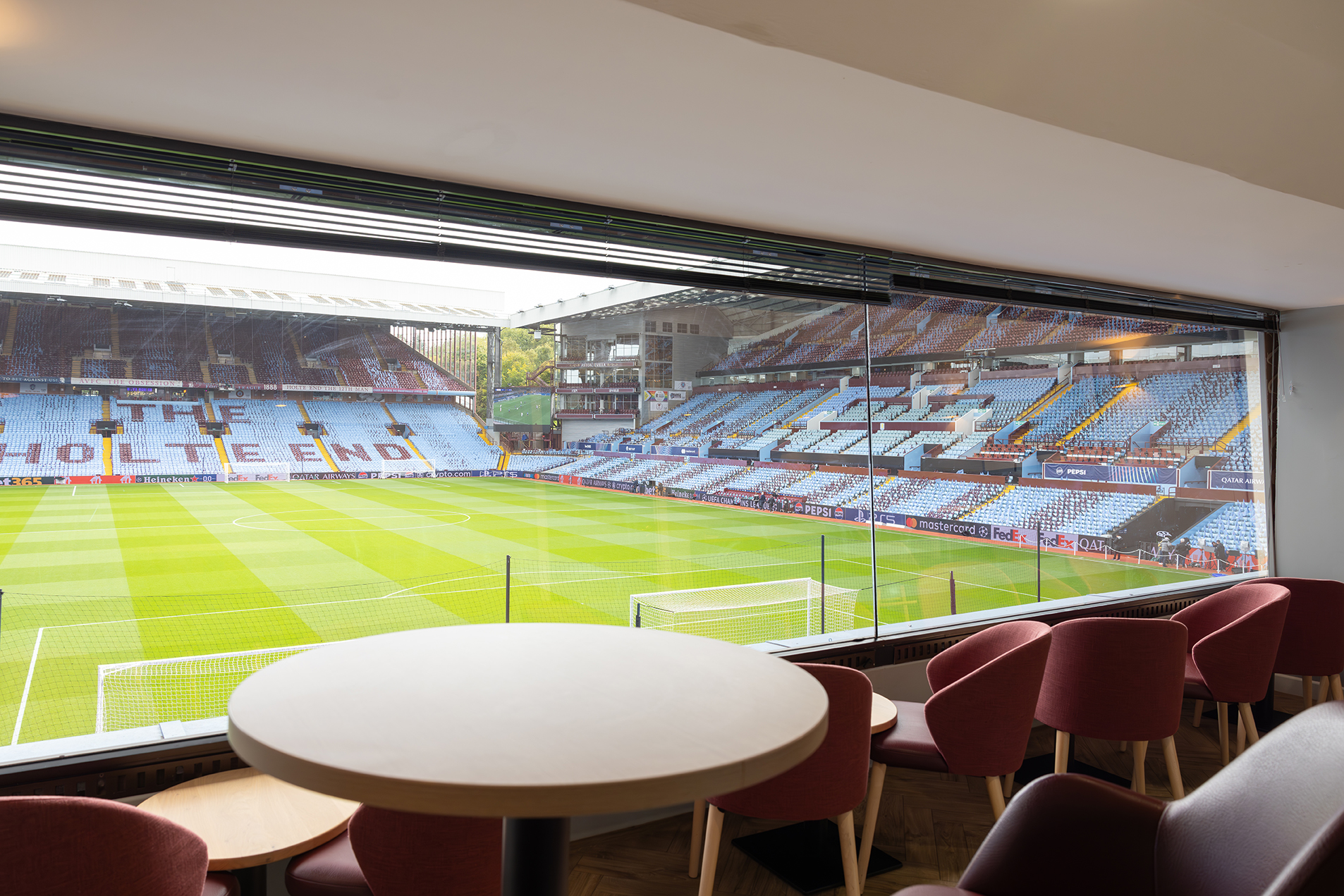 The interior of a Gas Lamp Box, behind glass and overlooking the Villa Park pitch from behind the goal