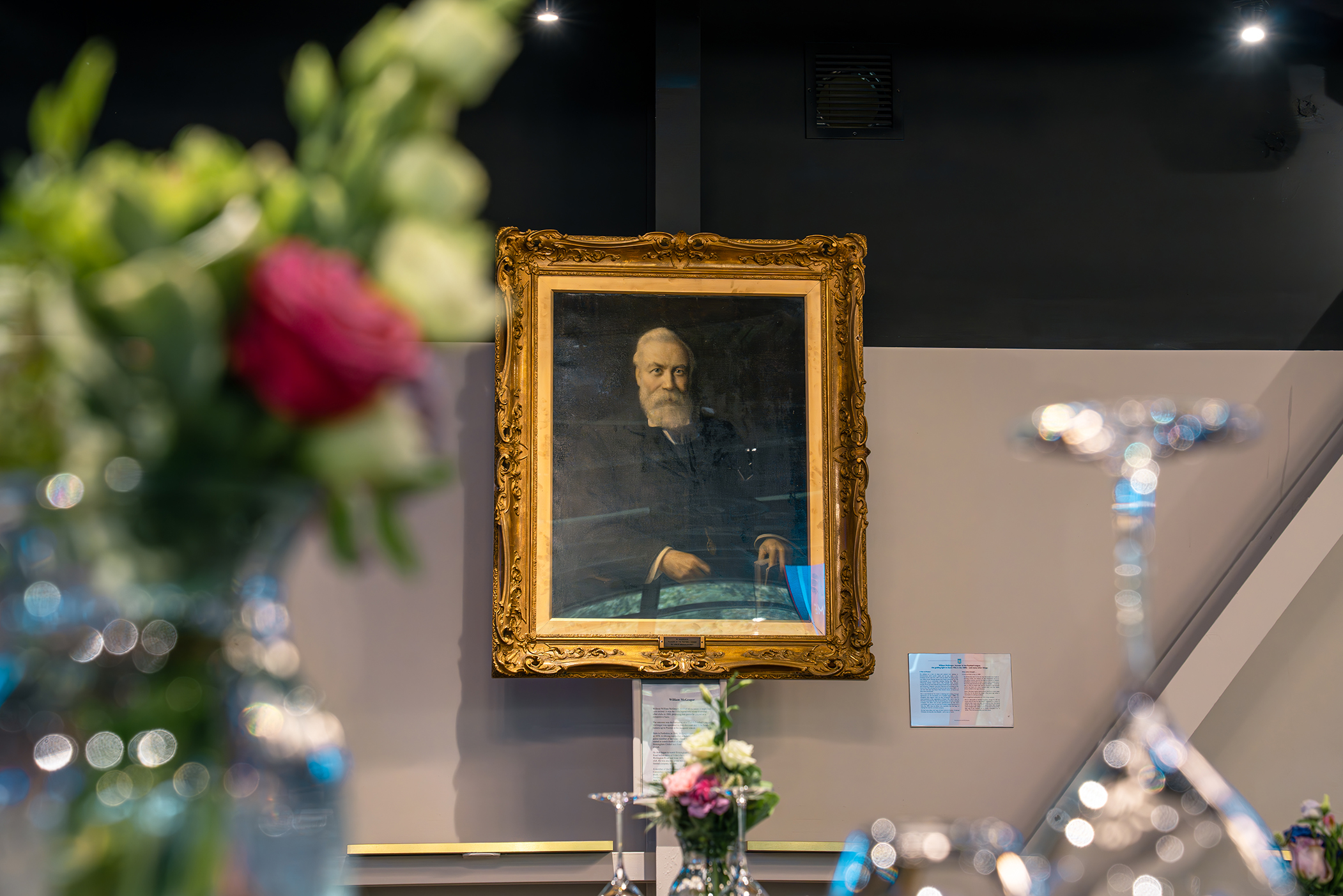 A painting of William McGregor on the wall of the hospitality space